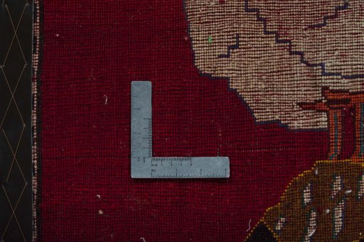Backside of handmade 2000s Persian Gabbeh rug showing knot structure and weave density