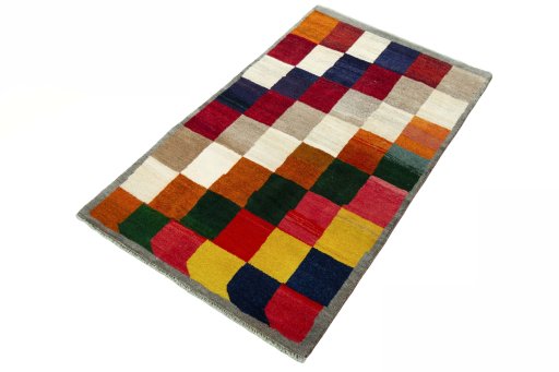 Corner detail of 2000s Persian Gabbeh rug showing border pattern and Wool pile