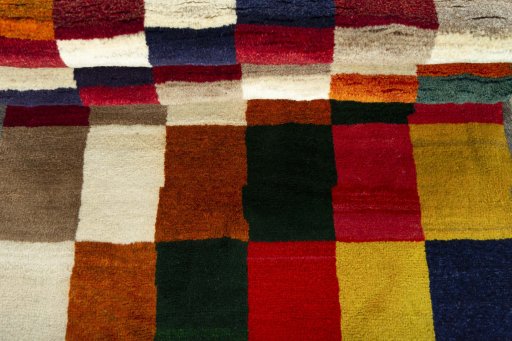 Full view of 2000s Persian Gabbeh rug from Iran / Persia, 187 × 105 cm in Multi Color tones