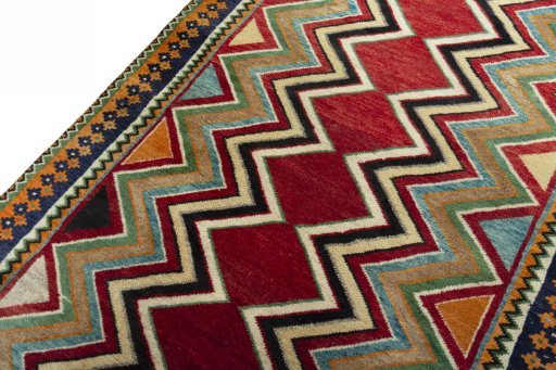 Backside of handmade 2000s Persian Gabbeh rug showing knot structure and weave density