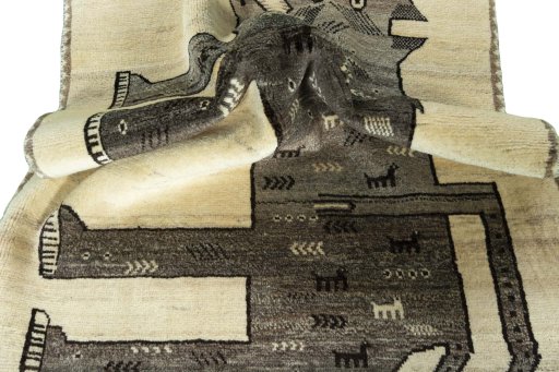 Corner detail of 2000s Persian Gabbeh rug showing border pattern and Wool pile