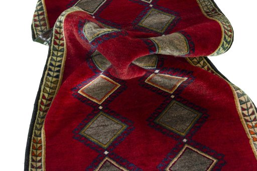 Corner detail of 2000s Persian Gabbeh rug showing border pattern and Wool pile