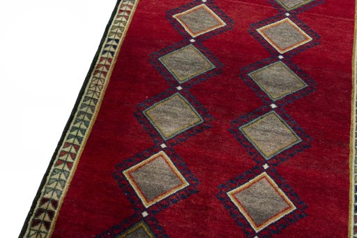 Backside of handmade 2000s Persian Gabbeh rug showing knot structure and weave density