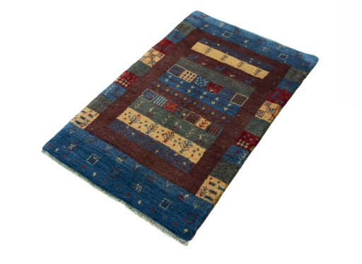 Corner detail of 2000s Persian Gabbeh rug showing border pattern and Wool pile