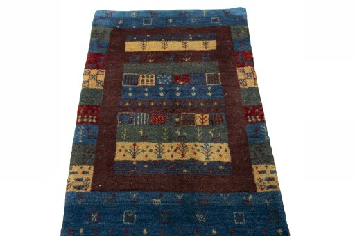 Surface texture of 2000s Persian Gabbeh rug with natural Wool and intricate pattern