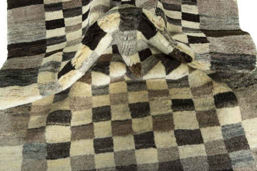 Corner detail of 2000s Persian Gabbeh rug showing border pattern and Wool pile