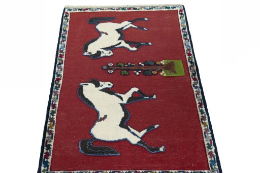 Surface texture of 2000s Persian Gabbeh rug with natural Wool and intricate pattern