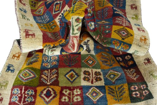Corner detail of 2000s Persian Gabbeh rug showing border pattern and Wool pile