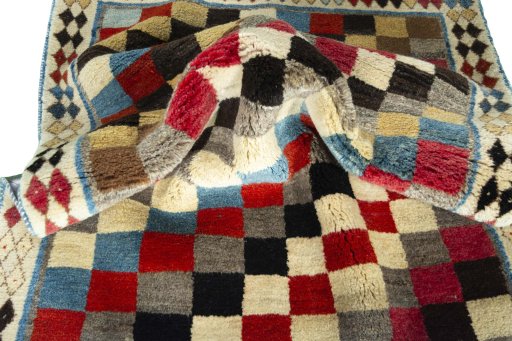 Corner detail of 2000s Persian Gabbeh rug showing border pattern and Wool pile