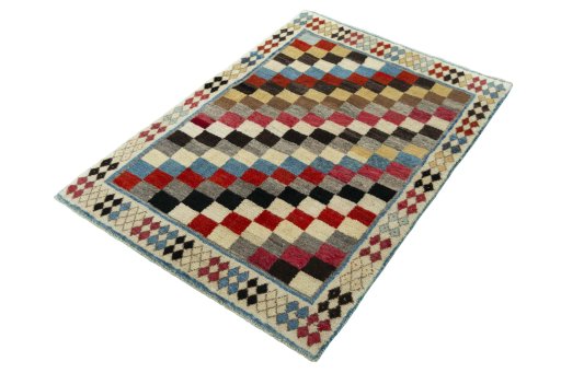 Corner detail of 2000s Persian Gabbeh rug showing border pattern and Wool pile