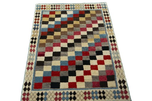 Surface texture of 2000s Persian Gabbeh rug with natural Wool and intricate pattern