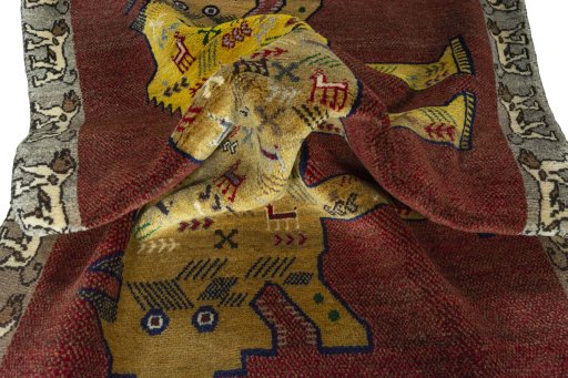 Corner detail of 2000s Persian Gabbeh rug showing border pattern and Wool pile