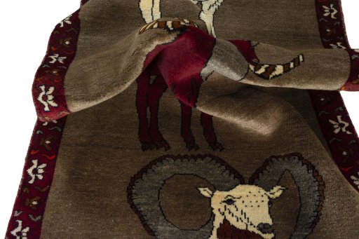 Corner detail of 2000s Persian Gabbeh rug showing border pattern and Wool pile