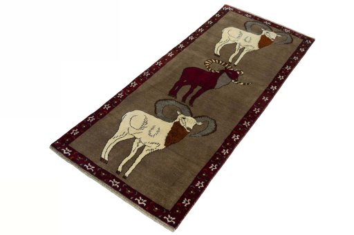 Corner detail of 2000s Persian Gabbeh rug showing border pattern and Wool pile