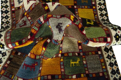 Corner detail of 2000s Persian Gabbeh rug showing border pattern and Wool pile