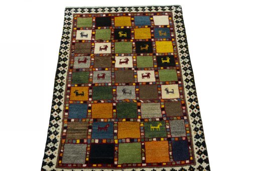 Surface texture of 2000s Persian Gabbeh rug with natural Wool and intricate pattern