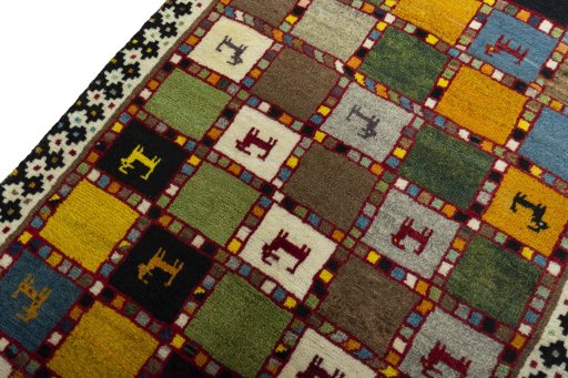 Backside of handmade 2000s Persian Gabbeh rug showing knot structure and weave density