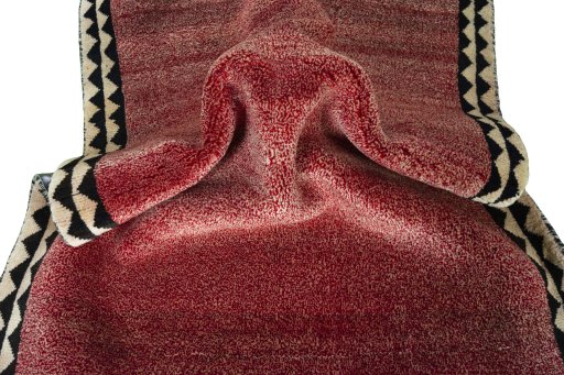 Corner detail of 2000s Persian Gabbeh rug showing border pattern and Wool pile