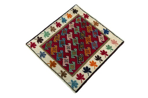 Corner detail of 2000s Persian Gabbeh rug showing border pattern and Wool pile