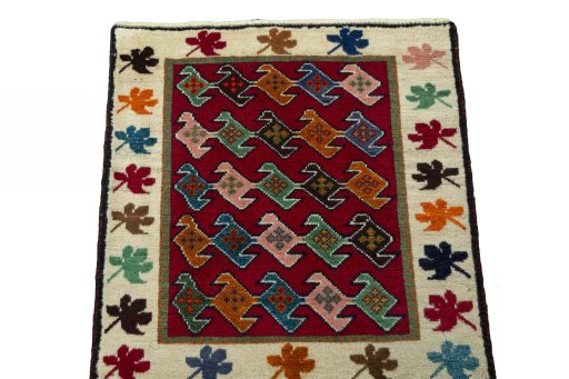Surface texture of 2000s Persian Gabbeh rug with natural Wool and intricate pattern