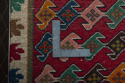 Backside of handmade 2000s Persian Gabbeh rug showing knot structure and weave density