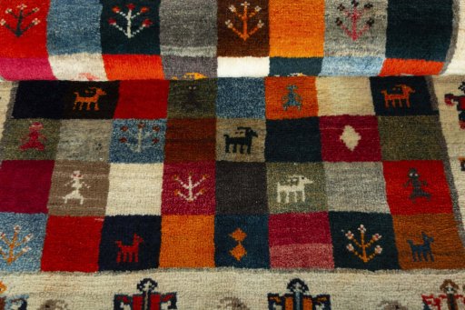 Full view of 2000s Persian Gabbeh rug from Iran / Persia, 120 × 85 cm in Multi Color tones
