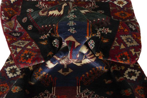 Corner detail of 2000s Persian Gabbeh rug showing border pattern and Wool pile