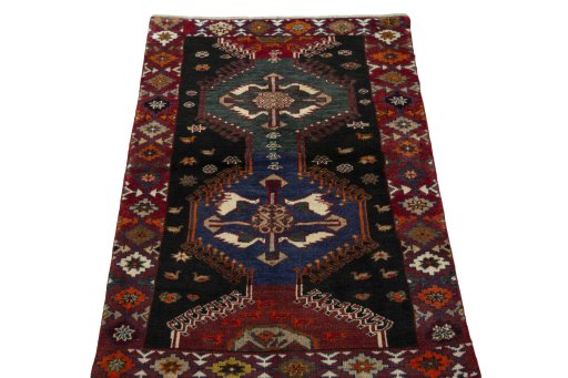 Surface texture of 2000s Persian Gabbeh rug with natural Wool and intricate pattern