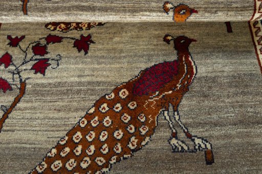 Full view of 2000s Persian Gabbeh rug from Iran / Persia, 176 × 105 cm in Beige tones