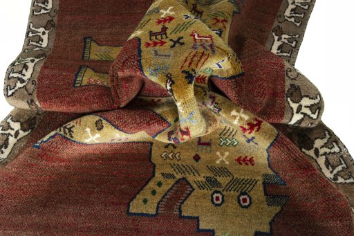 Corner detail of 2000s Persian Gabbeh rug showing border pattern and Wool pile