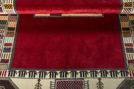 Corner detail of 2000s Persian Gabbeh rug showing border pattern and Wool pile