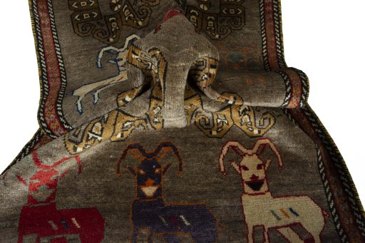 Corner detail of 2000s Persian Gabbeh rug showing border pattern and Wool pile