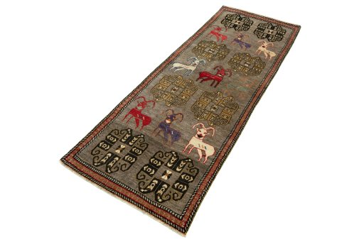 Corner detail of 2000s Persian Gabbeh rug showing border pattern and Wool pile
