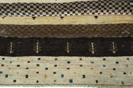 Corner detail of 2000s Persian Gabbeh rug showing border pattern and Wool pile