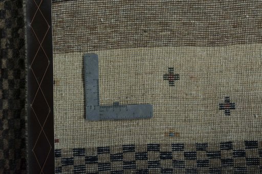 Surface texture of 2000s Persian Gabbeh rug with natural Wool and intricate pattern