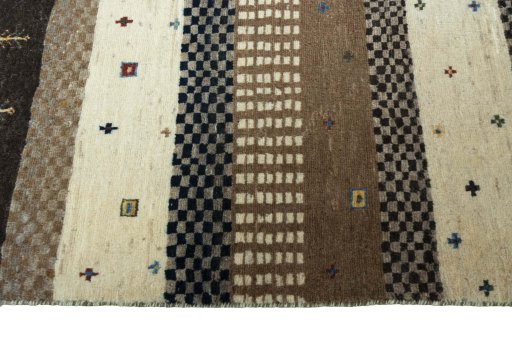 Full view of 2000s Persian Gabbeh rug from Iran / Persia, 128 × 87 cm in Beige tones