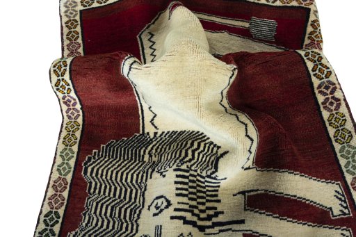 Corner detail of 2000s Persian Gabbeh rug showing border pattern and Wool pile