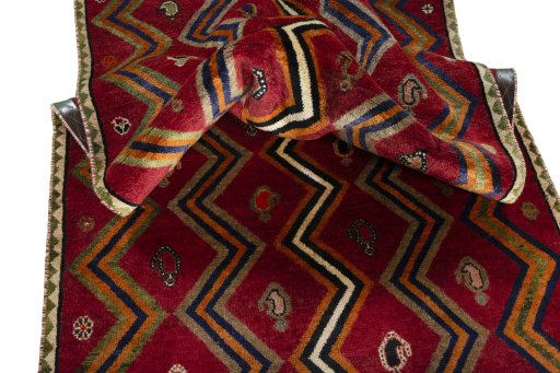 Corner detail of 2000s Persian Gabbeh rug showing border pattern and Wool pile
