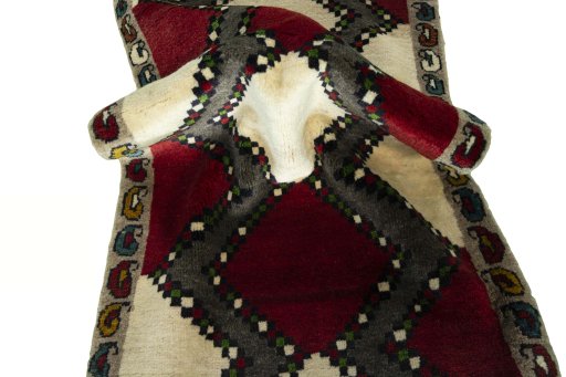 Corner detail of 2000s Persian Gabbeh rug showing border pattern and Wool pile
