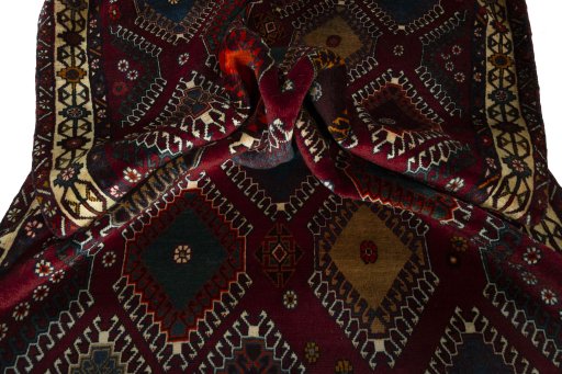 Corner detail of 2000s Persian Gabbeh rug showing border pattern and Wool pile