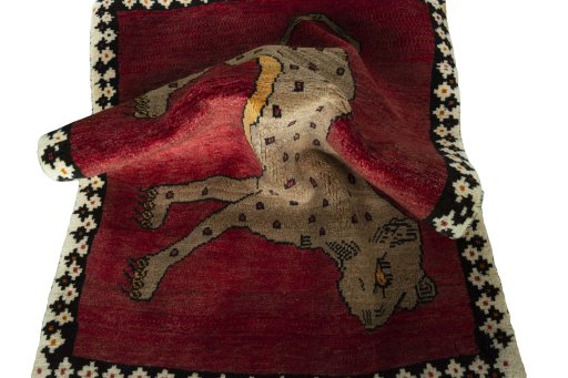 Corner detail of 2000s Persian Gabbeh rug showing border pattern and Wool pile