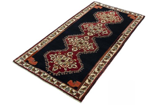 Corner detail of 2000s Persian Gabbeh rug showing border pattern and Wool pile