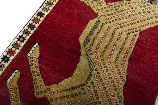 Backside of handmade 2000s Persian Gabbeh rug showing knot structure and weave density