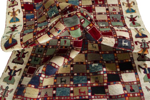 Corner detail of 2000s Persian Gabbeh rug showing border pattern and Wool pile