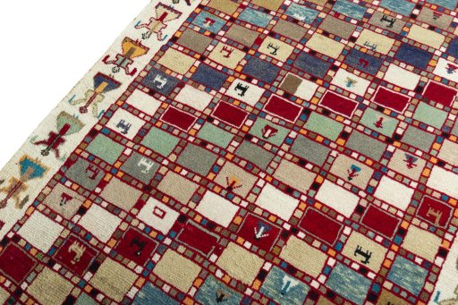 Backside of handmade 2000s Persian Gabbeh rug showing knot structure and weave density