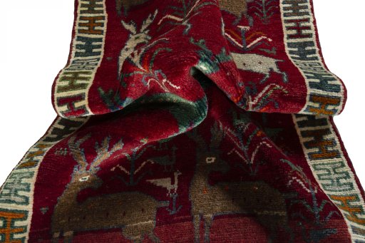 Corner detail of 2000s Persian Gabbeh rug showing border pattern and Wool pile