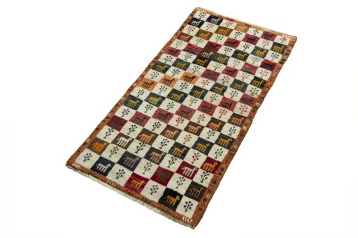 Corner detail of 2000s Persian Gabbeh rug showing border pattern and Wool pile