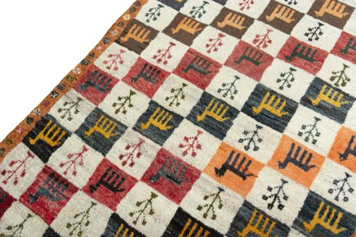 Backside of handmade 2000s Persian Gabbeh rug showing knot structure and weave density