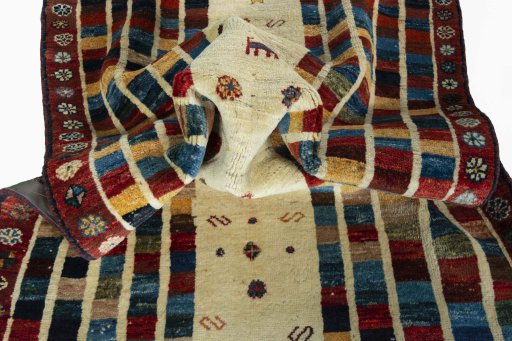 Corner detail of 2000s Persian Gabbeh rug showing border pattern and Wool pile