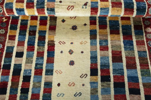 Full view of 2000s Persian Gabbeh rug from Iran / Persia, 184 × 106 cm in Beige tones